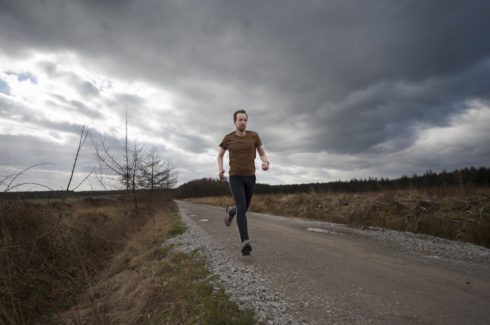 man running at the road during daytime