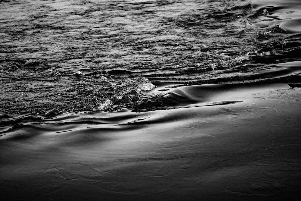 grayscale photo of water waves