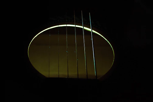 Close-up shot from an atmospheric music video with subtle gold highlights and cinematic lighting.