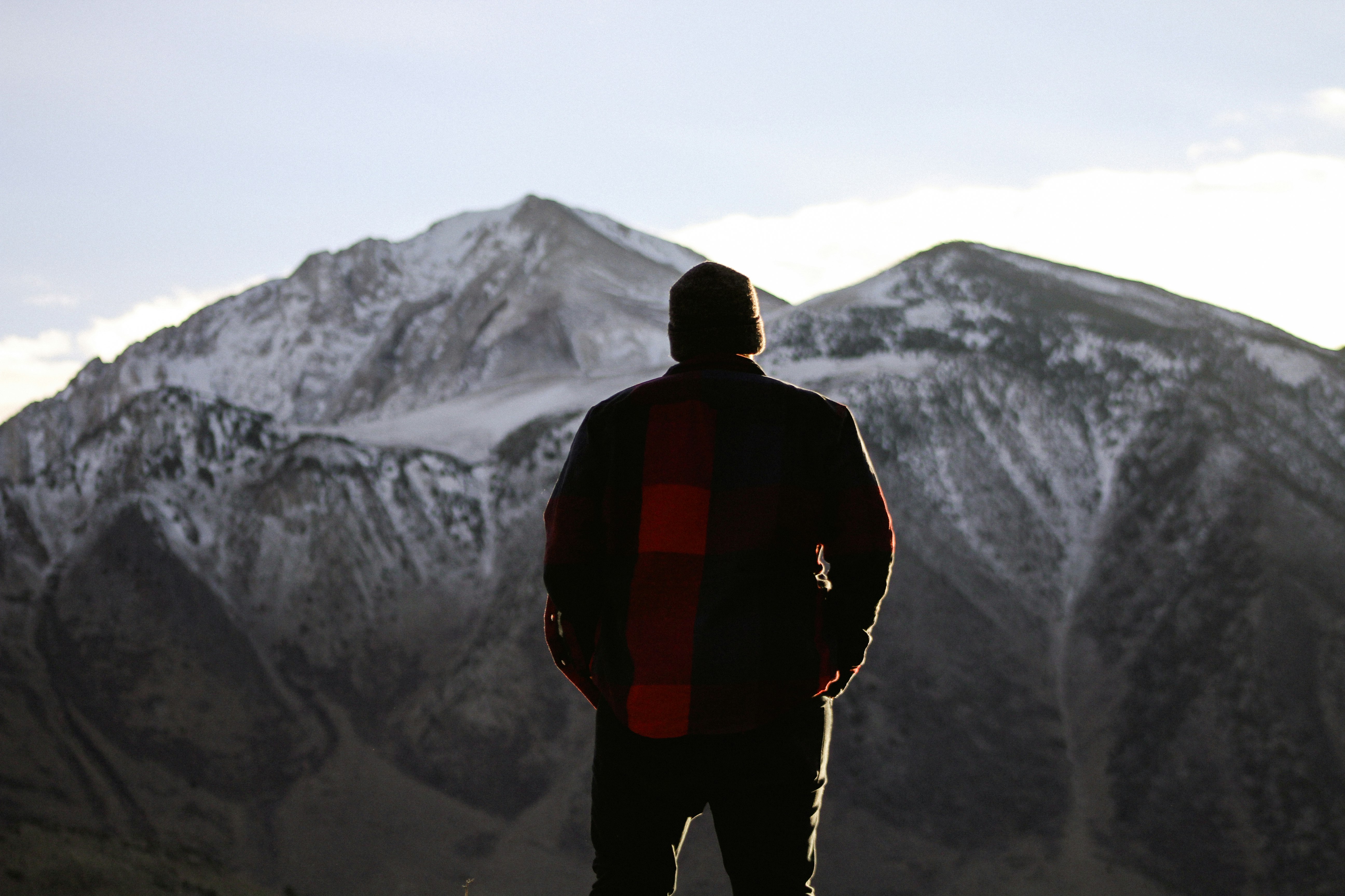 man standing while looking at the mountain