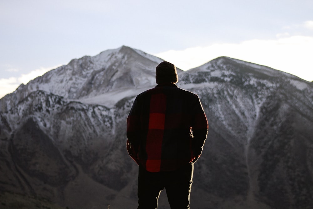 Mann steht und schaut auf den Berg