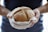 A satisfied customer holding a loaf of Psychevals sweet bread.