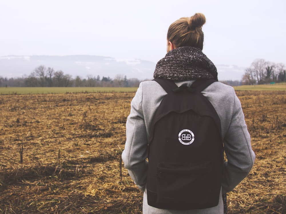 person carrying backpack near field