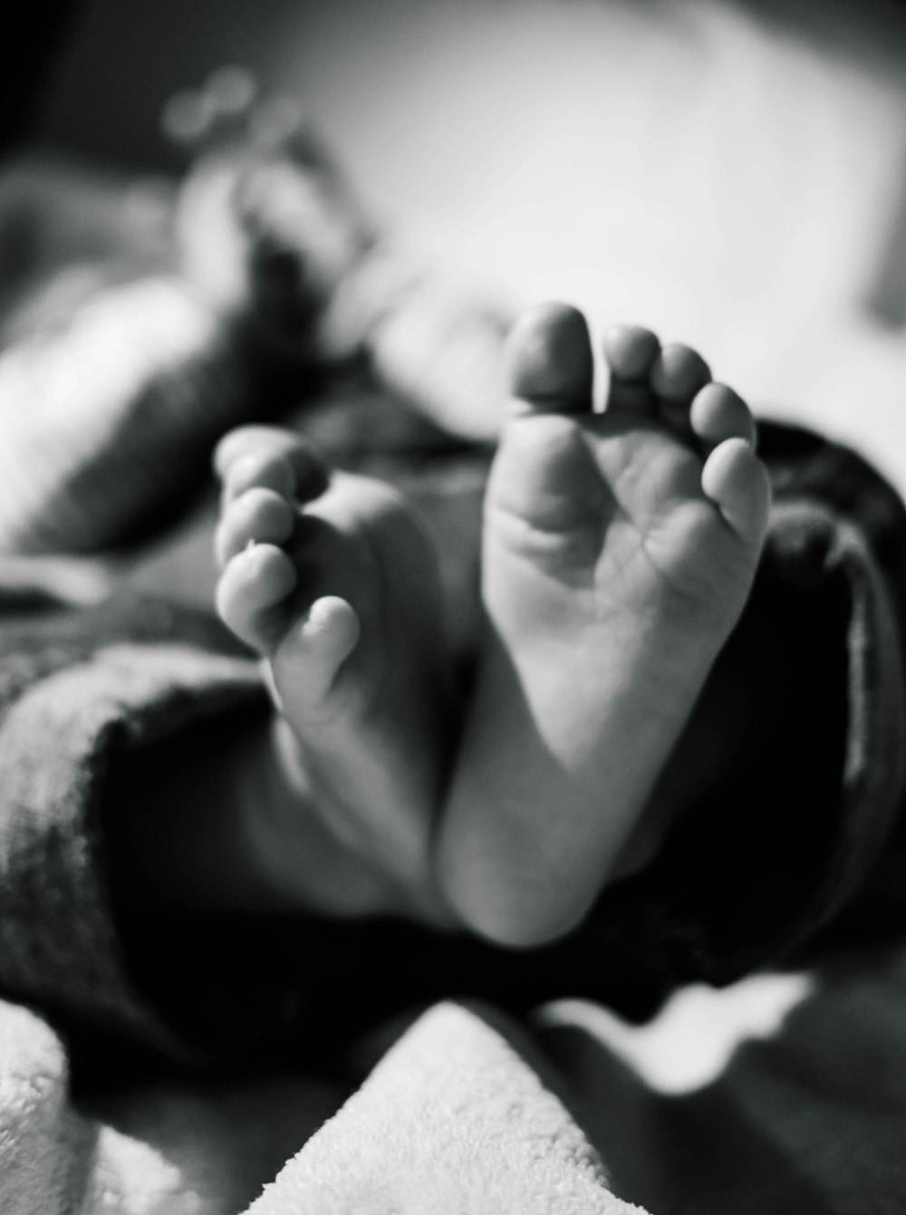 grayscale photo of baby's feet