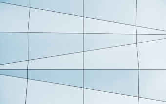 A grid pattern with intersecting lines creating various quadrilateral shapes. The colors are primarily light blue with a hint of gray.