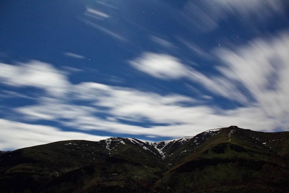 selective focus photography of mountain and clouds