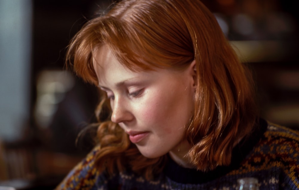 woman wearing knit top near chair