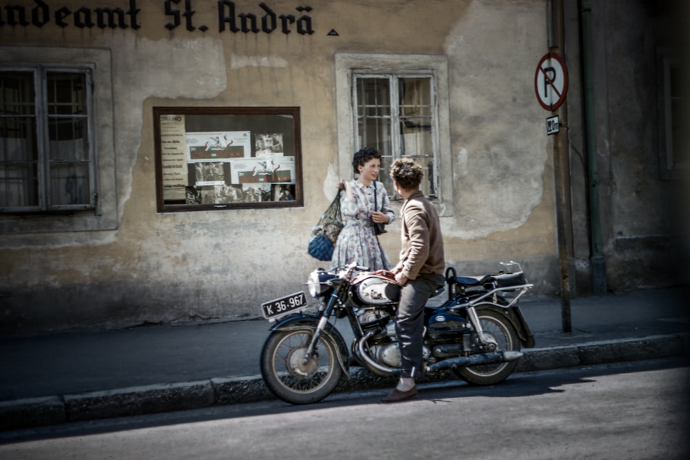 a man and a woman sitting on a motorcycle