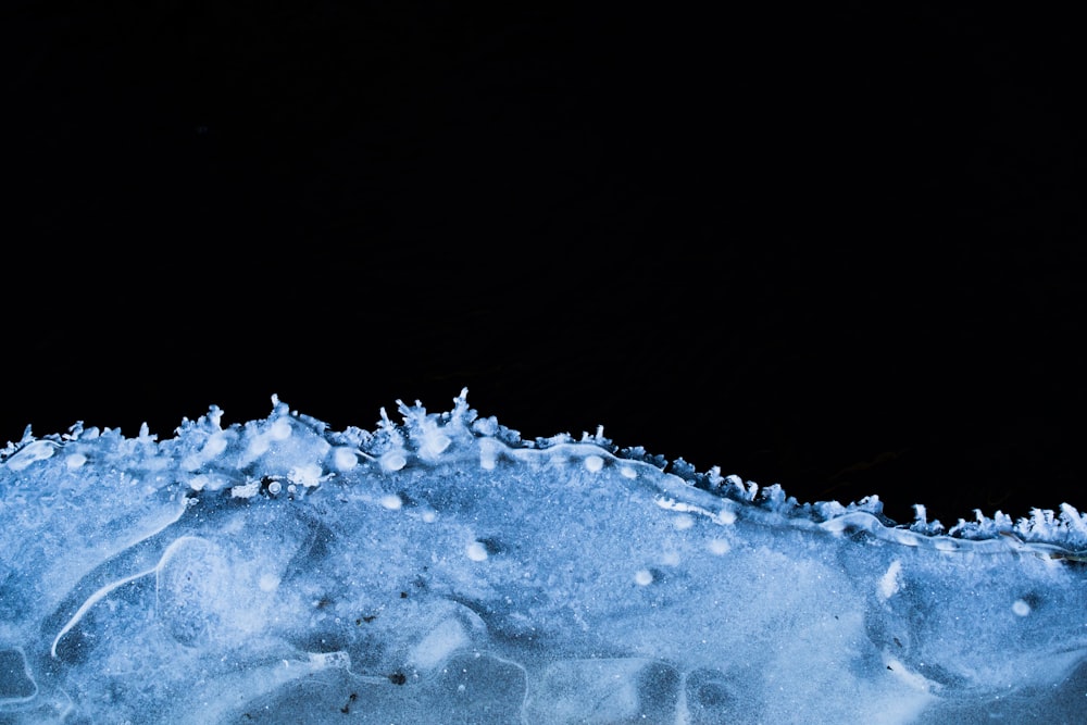 a close up of snow on a black background