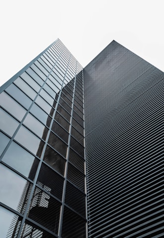 low angle photography of black glass building