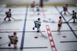 Close-up of a strategic tabletop hockey match.
