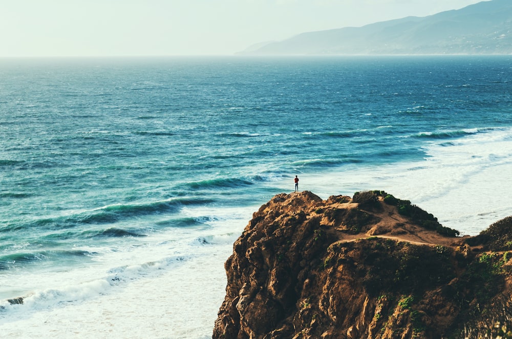 person standing near body of water