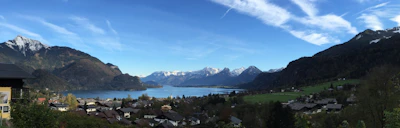 A panoramic view of Tsomgo Lake with a cab waiting nearby for travelers.