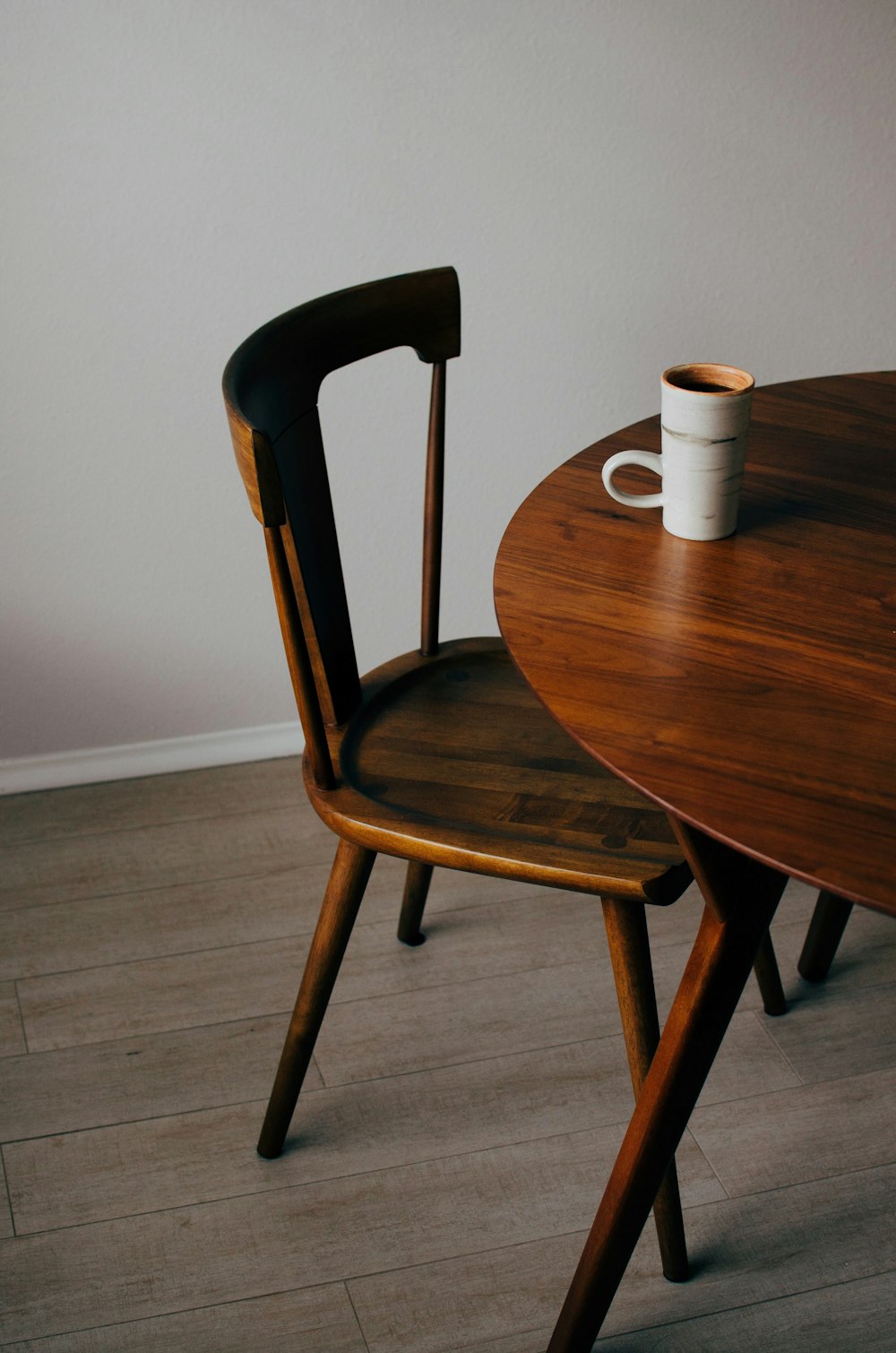 white ceramic mug on brown wooden table