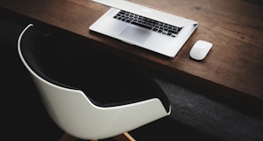 Apple MacBook beside computer mouse on table