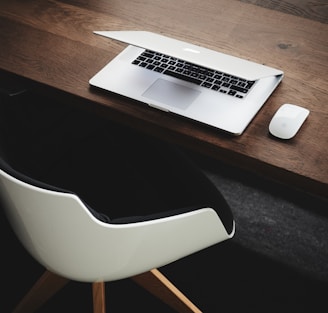 Apple MacBook beside computer mouse on table