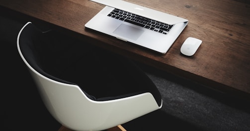 Apple MacBook beside computer mouse on table