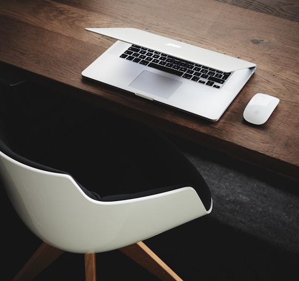 Apple MacBook beside computer mouse on table