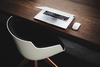 Apple MacBook beside computer mouse on table