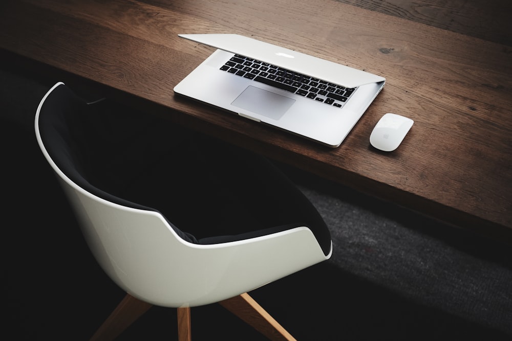 Apple MacBook beside computer mouse on table