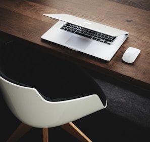 Apple MacBook beside computer mouse on table