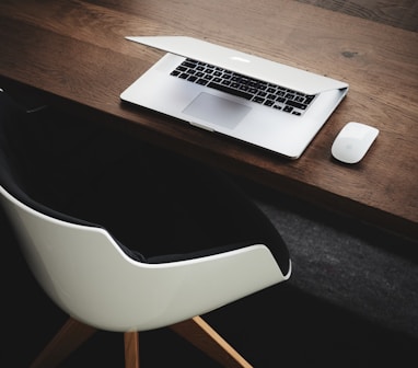 Apple MacBook beside computer mouse on table