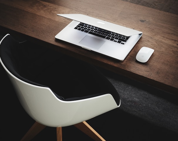 Apple MacBook beside computer mouse on table