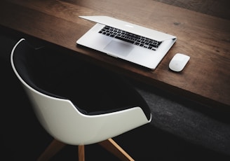 Apple MacBook beside computer mouse on table