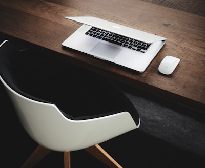 Apple MacBook beside computer mouse on table