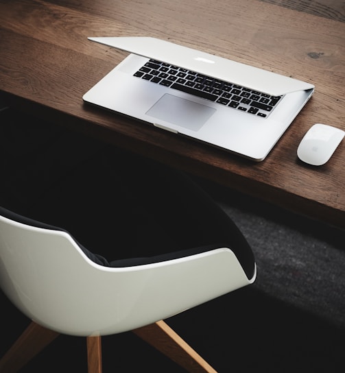 Apple MacBook beside computer mouse on table