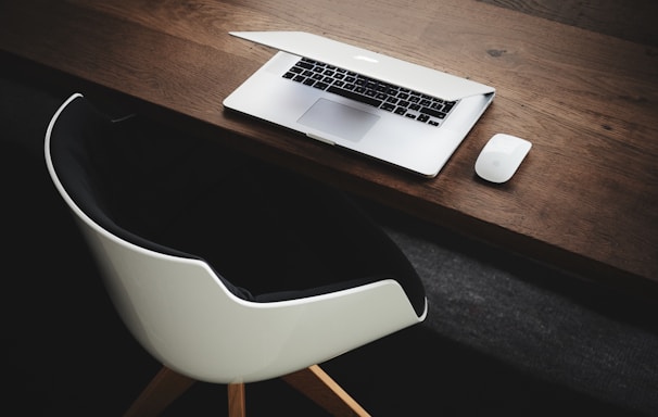 Apple MacBook beside computer mouse on table