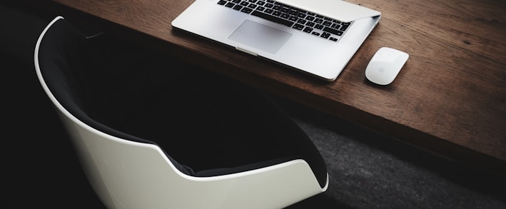 Apple MacBook beside computer mouse on table