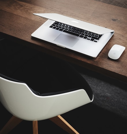 Apple MacBook beside computer mouse on table