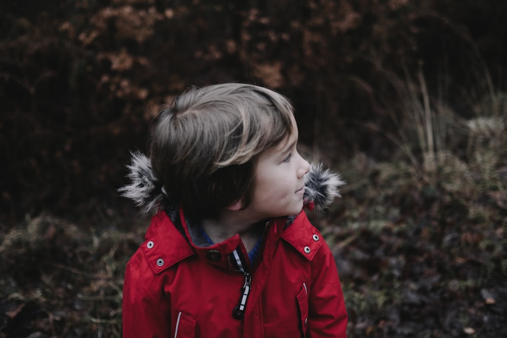 boy wearing red parka jacket