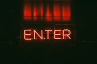 A neon-lit entrance of the nightclub inviting guests inside.