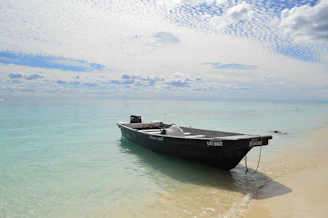 A small boat anchored near the hidden beach, inviting visitors for an exclusive tour.