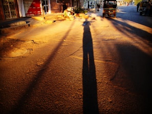 A clean and shiny Rodways cab parked by a busy Patna street at sunset