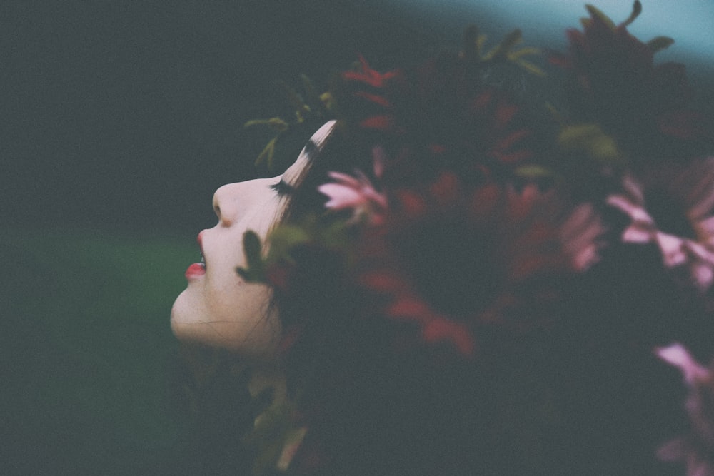 red and pink flower headdress on woman's head