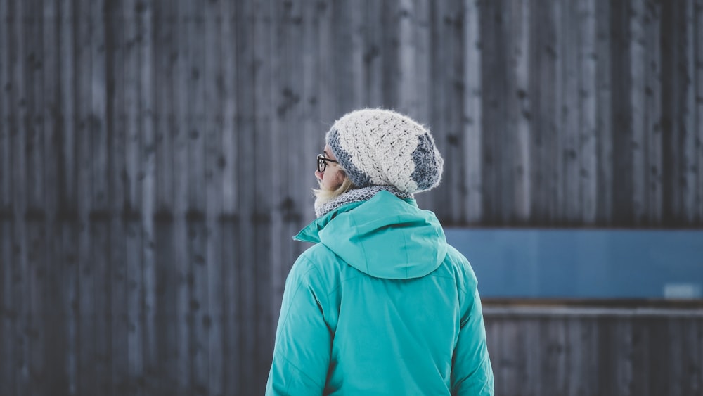 selective focus photography of woman facing wall