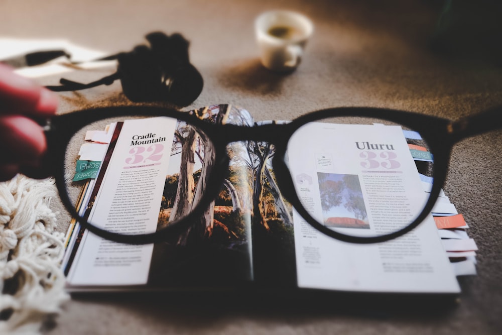 eyeglasses with brown frames and open book