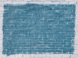 A freshly painted exterior brick wall showcasing a smooth, bold color finish.