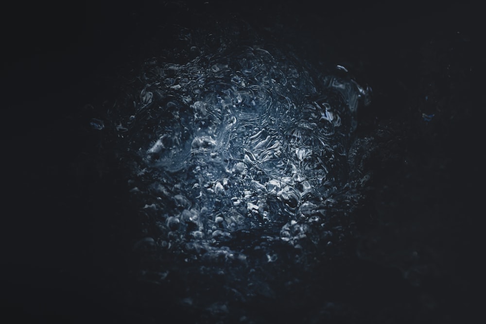 a close up of a black surface with water