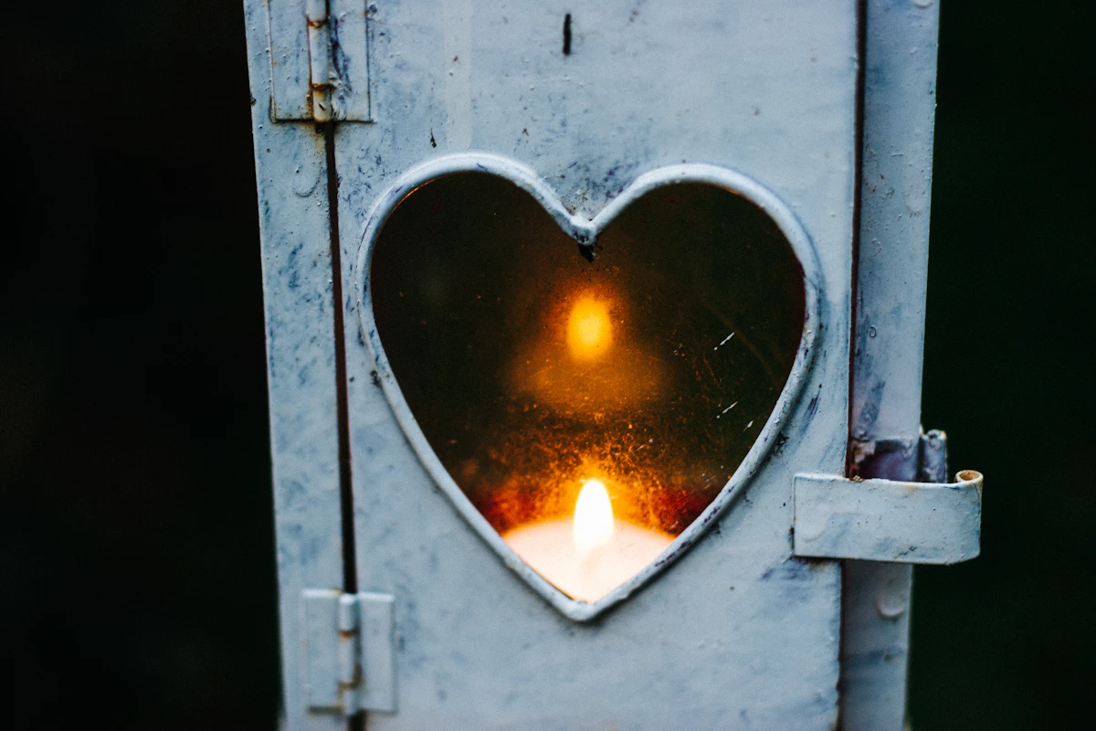 A candle lantern glowing warmly in the dark