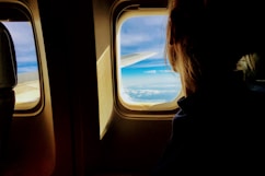person looking outside of airplane window