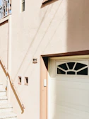Before and after shot of a stucco repair on a residential building facade.