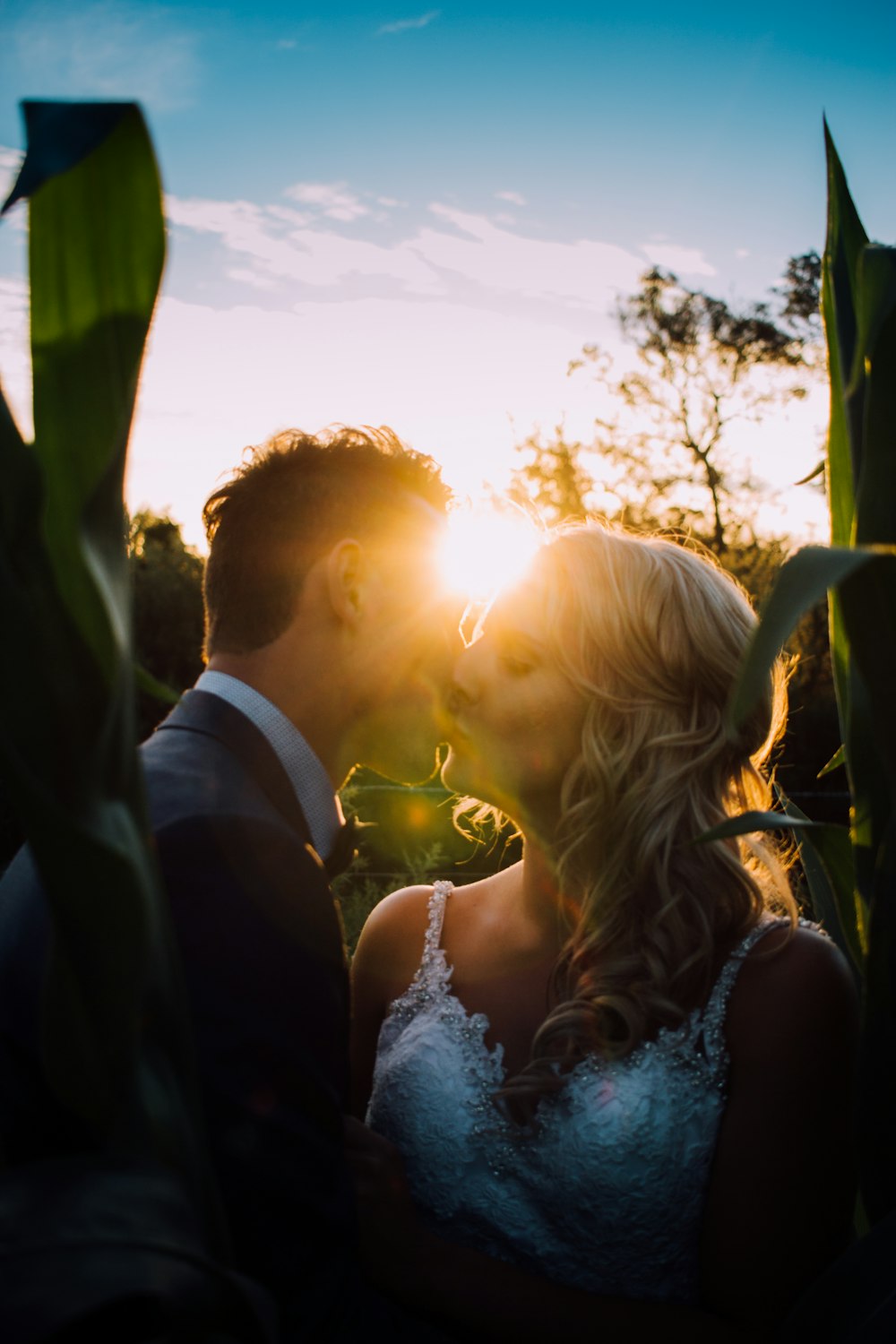 woman and man kissing on grass field