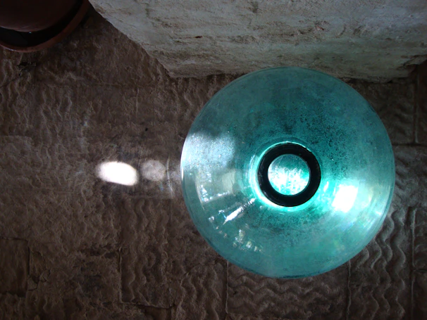 Close-up of a vibrant hand-carved marble bowl glowing under soft natural light.