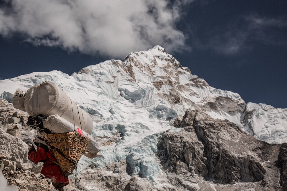 man near mountain under cloudy blue sku