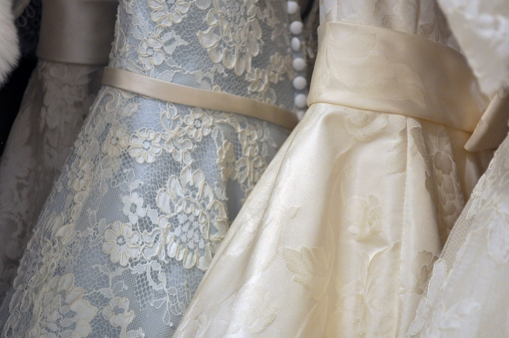 Multiple lace wedding dresses in a row
