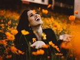 woman laughing on flower field